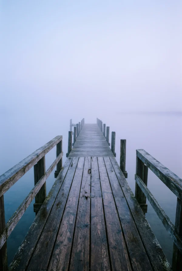 Weathered Wooden Pier in Morning Fog
