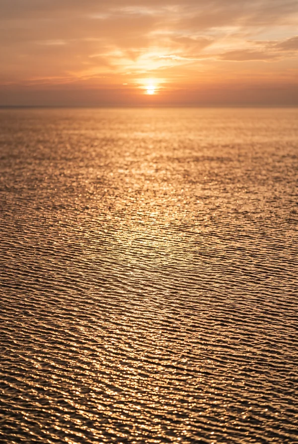 Golden Sunset Ripples on the Ocean Surface