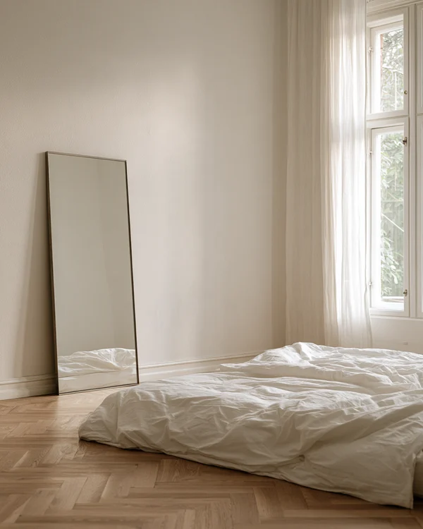 Minimalist Bedroom with Mirror and Bed