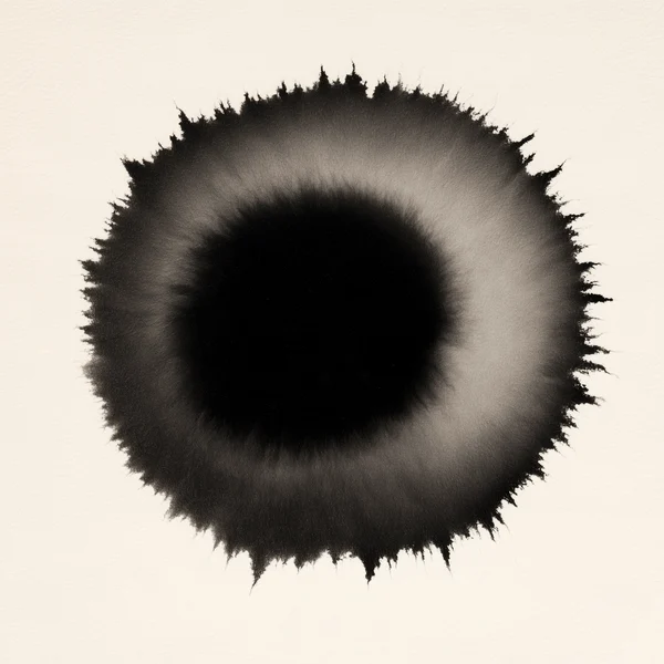 Black Ink Bloom on Textured Paper