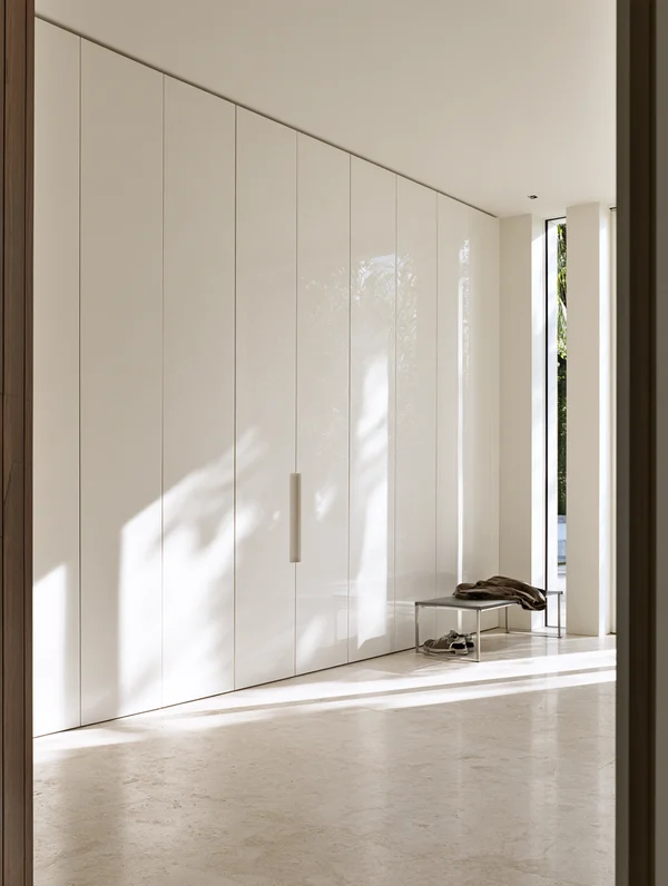 Minimalist Hallway with Glossy Storage Wall