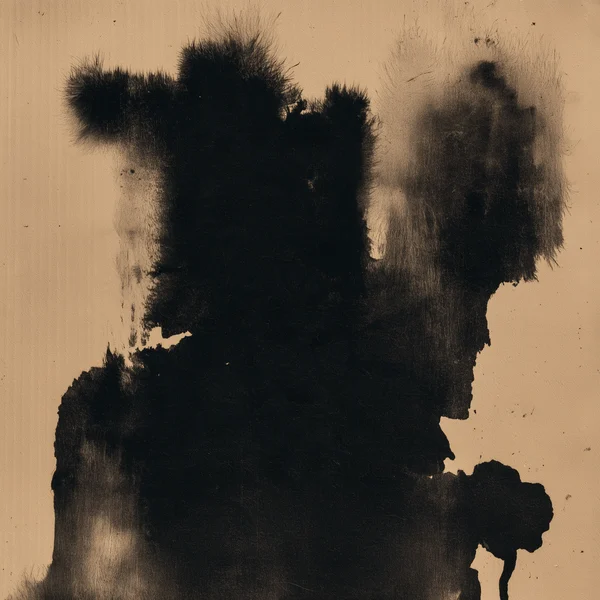 Abstract Black Ink Stain on Tan Paper