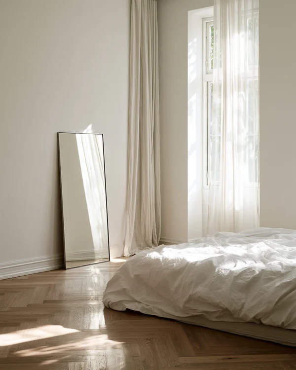 Minimalist Bedroom with Mirror and Natural Light