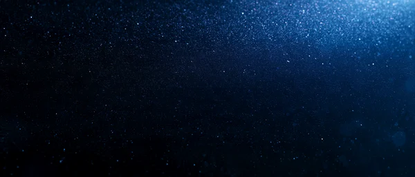 Dark Blue Glittering Particle Background