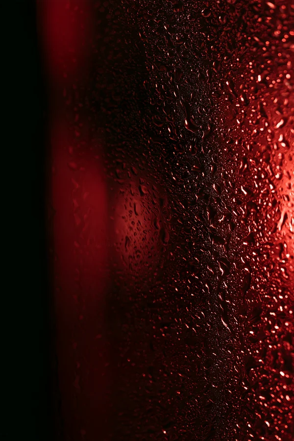 Water Droplets on Red Glass